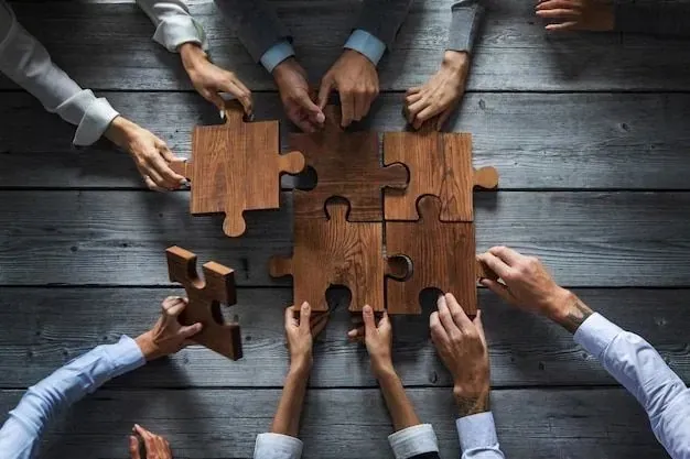 Hands fitting wooden puzzle pieces together on a table, representing connected HR modules